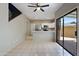 Bright living room with open floor plan featuring stainless appliances and a sliding glass door to the patio at 2051 W Ronald Rd, Phoenix, AZ 85029