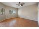 Sunlit living room with wood flooring and two large windows bringing in natural light at 2051 W Ronald Rd, Phoenix, AZ 85029