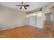 Inviting living room featuring wood flooring, ceiling fan and a cozy built in shelving unit at 2051 W Ronald Rd, Phoenix, AZ 85029