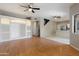 Spacious living room with wood flooring, built in shelving and ceiling fan for added comfort at 2051 W Ronald Rd, Phoenix, AZ 85029
