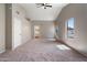 Vaulted main bedroom with ensuite bathroom, plush carpet, and ceiling fan at 2051 W Ronald Rd, Phoenix, AZ 85029