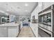 Modern kitchen featuring white cabinets, a large island, and stainless steel appliances at 22870 E Parkside Dr, Queen Creek, AZ 85142