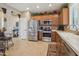 Well-equipped kitchen featuring stainless steel appliances, warm wood cabinets, and a neutral tile backsplash at 2309 W Firethorn Way, Anthem, AZ 85086