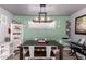 Well-lit dining room with a modern chandelier, seating for six, and stylish decor at 2328 W Echo Ln, Phoenix, AZ 85021