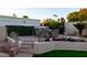 Picturesque backyard featuring a cozy dining area adorned with vibrant flowers and lush greenery at 2548 E Vermont Ave, Phoenix, AZ 85016