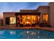 This backyard boasts a refreshing pool and a cozy seating area complete with a charming fire pit at 2548 E Vermont Ave, Phoenix, AZ 85016