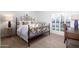 Bedroom with a decorative iron bed frame, neutral walls, and light carpet creates a cozy retreat at 2548 E Vermont Ave, Phoenix, AZ 85016