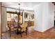 Open dining area with tiled floors, wood beam ceilings, and views of the kitchen and outdoor patio at 2548 E Vermont Ave, Phoenix, AZ 85016