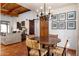 Cozy dining area with terracotta floors and a rustic chandelier, seamlessly connects to the inviting living room at 2548 E Vermont Ave, Phoenix, AZ 85016