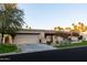 Well-maintained single-story home featuring a spacious driveway, lush landscaping, and desert plants at 2548 E Vermont Ave, Phoenix, AZ 85016