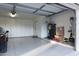 Clean and organized garage featuring white cabinets, epoxy flooring, and ample storage space at 2548 E Vermont Ave, Phoenix, AZ 85016