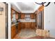 Charming kitchen with custom wood cabinetry, stainless steel appliances and unique backsplash tile detailing at 2548 E Vermont Ave, Phoenix, AZ 85016