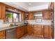 Well-lit kitchen featuring stainless steel appliances, green stone counters, and custom wood cabinets at 2548 E Vermont Ave, Phoenix, AZ 85016