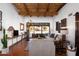 Bright living room with wood beam ceilings, hardwood floors, and sliding glass doors to the outdoor patio at 2548 E Vermont Ave, Phoenix, AZ 85016