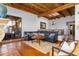 Comfortable living room with wood beam ceiling, skylight, fireplace, hardwood floors, and stylish furniture at 2548 E Vermont Ave, Phoenix, AZ 85016