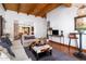 Comfortable living room featuring hardwood floors, modern lighting, and views into the dining area at 2548 E Vermont Ave, Phoenix, AZ 85016