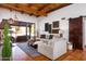 Bright living room with wood beam ceilings, tiled floors, and sliding glass doors to the outdoor patio at 2548 E Vermont Ave, Phoenix, AZ 85016