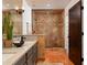 Luxurious main bathroom with a tiled walk-in shower, dual sinks, and a rustic wood door at 2548 E Vermont Ave, Phoenix, AZ 85016