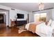 Comfortable main bedroom featuring hardwood floors, neutral tones, and an expansive sliding glass door at 2548 E Vermont Ave, Phoenix, AZ 85016