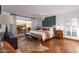 Serene main bedroom with hardwood floors, a decorative chandelier, and access to a private outdoor space at 2548 E Vermont Ave, Phoenix, AZ 85016