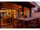 Cozy covered patio featuring an outdoor kitchen with bar seating and easy access to indoor dining at 2548 E Vermont Ave, Phoenix, AZ 85016