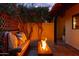 This outdoor patio offers a cozy fire pit area adorned with lush plants and comfortable seating at 2548 E Vermont Ave, Phoenix, AZ 85016