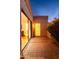 Charming patio featuring brick pavers, an illuminated glass block accent, and sliding glass doors to the interior at 2548 E Vermont Ave, Phoenix, AZ 85016