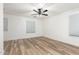 Bright, spacious bedroom featuring hardwood floors, a ceiling fan, and natural light from the windows at 2789 S Balsam Dr, Gilbert, AZ 85295