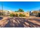 Community entrance with a gated entry surrounded by lush landscaping and paved roadway at 2789 S Balsam Dr, Gilbert, AZ 85295