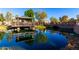 A view of the pond with a gazebo reflected in the calm, blue water at 2789 S Balsam Dr, Gilbert, AZ 85295