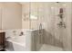 Bright bathroom featuring a soaker tub and glass enclosed standup shower at 2992 N Miller Rd # 219B, Scottsdale, AZ 85251