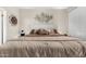 Comfortable bedroom featuring large bed, neutral tones and modern metal artwork at 2992 N Miller Rd # 219B, Scottsdale, AZ 85251