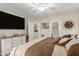 Bedroom boasts dresser, mounted TV, ceiling fan and ensuite bathroom access at 2992 N Miller Rd # 219B, Scottsdale, AZ 85251