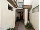 Inviting entryway with a red front door, desert landscaping and warm, neutral stucco walls at 2992 N Miller Rd # 219B, Scottsdale, AZ 85251
