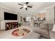 Bright, open-concept living area with ceiling fan, TV, open to dining and kitchen at 2992 N Miller Rd # 219B, Scottsdale, AZ 85251
