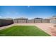 Low-maintenance backyard with artificial turf and desert landscaping, enclosed by a block wall at 30324 W Crittenden Ln, Buckeye, AZ 85396