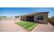 A well maintained backyard with an artificial turf and a block fence at 30324 W Crittenden Ln, Buckeye, AZ 85396
