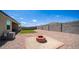Large backyard featuring a fire pit and block fence at 30324 W Crittenden Ln, Buckeye, AZ 85396
