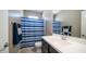 Bathroom featuring a sleek vanity with a blue striped shower curtain at 30324 W Crittenden Ln, Buckeye, AZ 85396