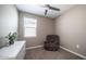 Cozy bedroom with a recliner, dresser and a bright window at 30324 W Crittenden Ln, Buckeye, AZ 85396