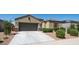 Charming single-story home with a well-manicured front yard and two car garage at 30324 W Crittenden Ln, Buckeye, AZ 85396