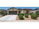 Inviting single-story home featuring a two-car garage, neutral stucco, and well-manicured landscaping at 30324 W Crittenden Ln, Buckeye, AZ 85396