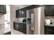 Kitchen featuring stainless steel refrigerator, granite countertops, and dark wood cabinets at 30324 W Crittenden Ln, Buckeye, AZ 85396