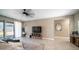 Comfortable living room featuring tile floors, ceiling fan and backyard access at 30324 W Crittenden Ln, Buckeye, AZ 85396