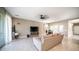 Spacious living room with tile flooring, contemporary ceiling fan, and access to the backyard at 30324 W Crittenden Ln, Buckeye, AZ 85396