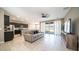 Open-concept living space with tile floors, modern ceiling fan, and sliding glass doors to the patio at 30324 W Crittenden Ln, Buckeye, AZ 85396