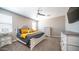 Main bedroom featuring neutral tones, plush carpeting, a ceiling fan, and ample natural light at 30324 W Crittenden Ln, Buckeye, AZ 85396