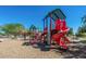 Community playground with slides, climbing walls, and covered play structures at 30324 W Crittenden Ln, Buckeye, AZ 85396