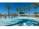 Community splash pad with palm tree features and shaded seating area at 30324 W Crittenden Ln, Buckeye, AZ 85396