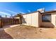 View of an enclosed backyard featuring a fence and desert landscaping under a bright blue sky at 3120 N 67Th Ln # 96, Phoenix, AZ 85033